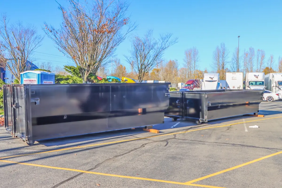 Professional dumpster rental service with roll-off container on residential driveway in Monson